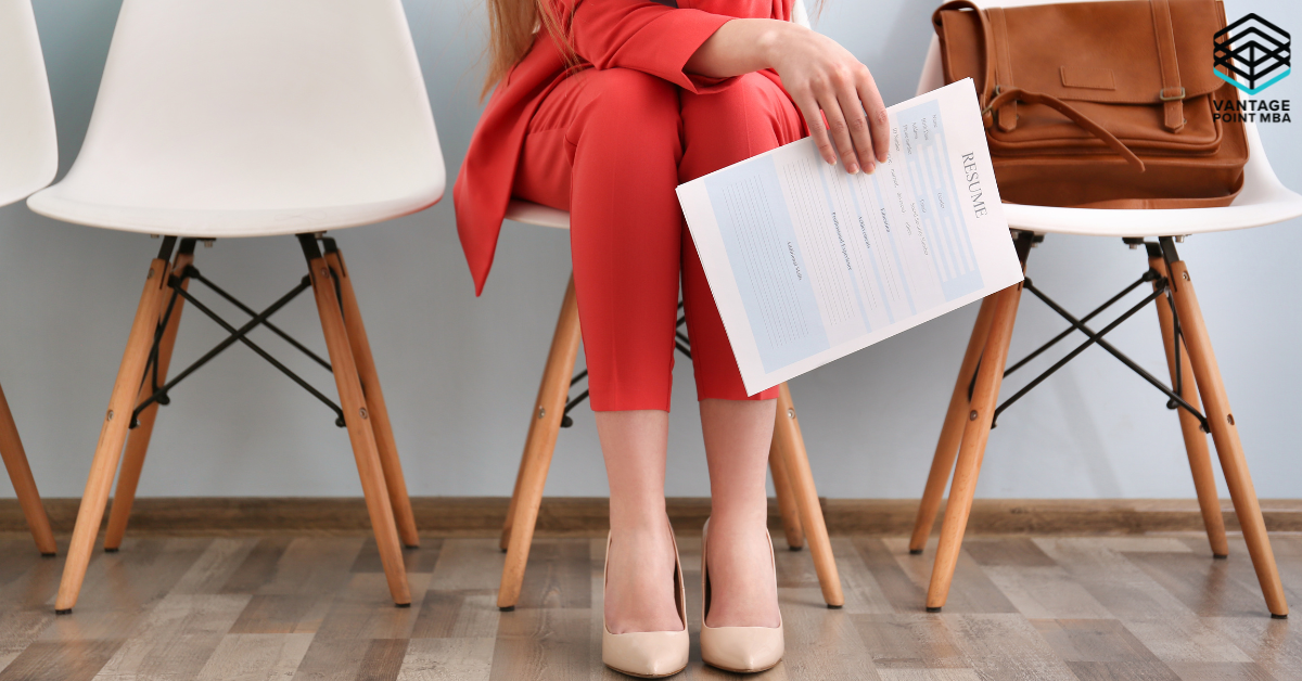 Woman sitting in a chair holding her MBA resume