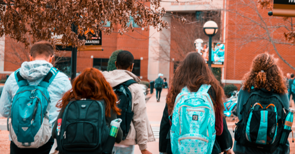 Undergraduate students walking together on a college campus