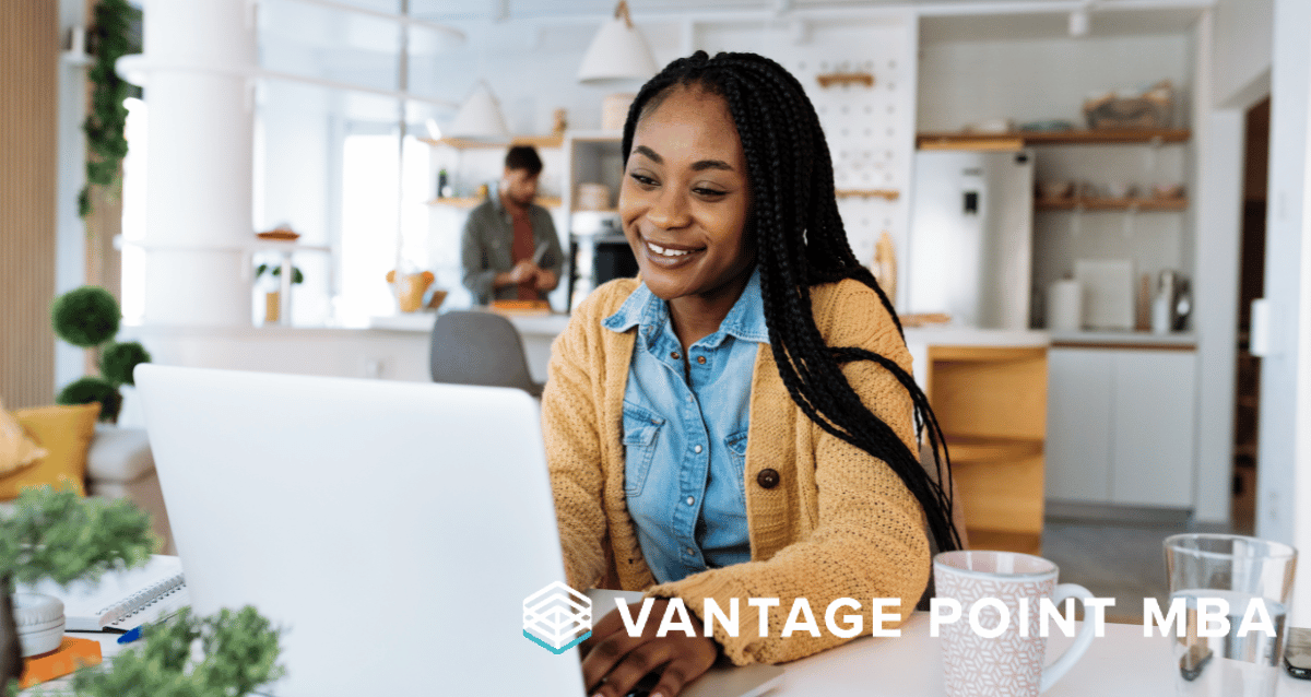 Young woman working on her laptop and smiling